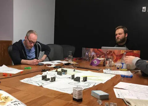 Teammates around a table playing a board game